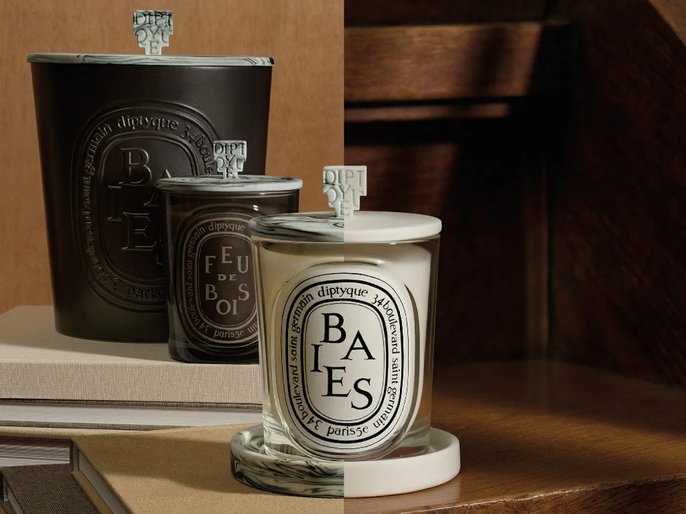 Diptyque Baies and Feu de Bois candles in several sizes with patterned lids