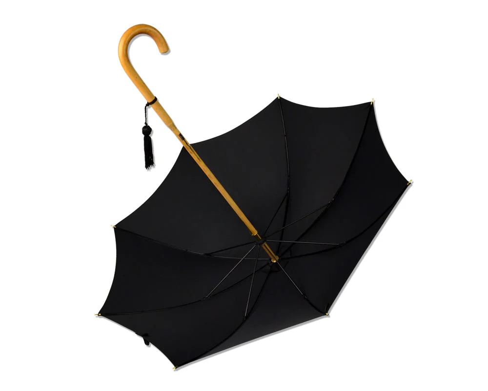 Open black Fox umbrella with a curved Malacca cane handle